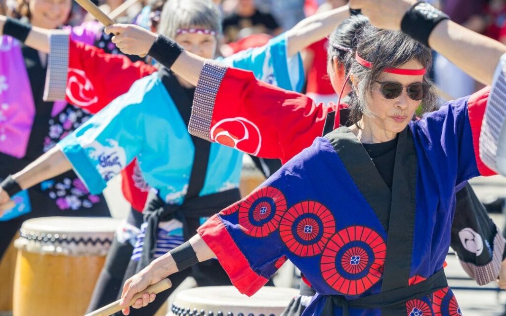 A group of indigenous women doing a cultural dance at the Steveston Salmon Festival