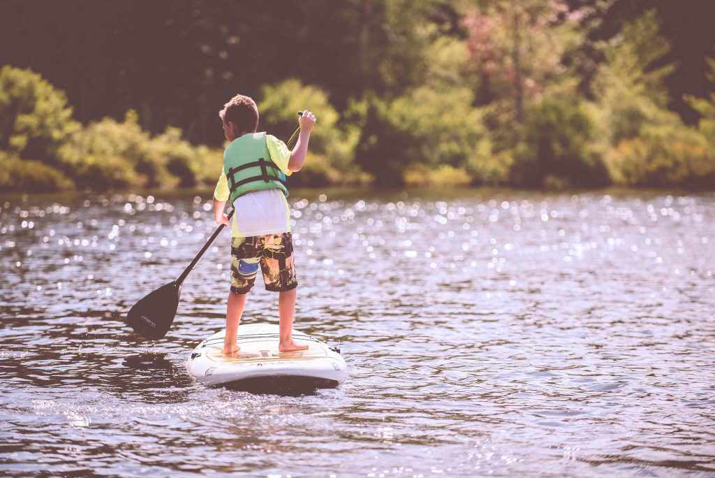 Kid on a stand up paddleboard