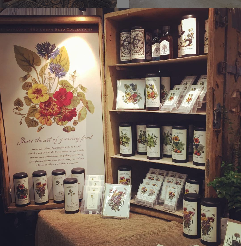 A cabinet various garden seeds packaged in tins, and envelopes.