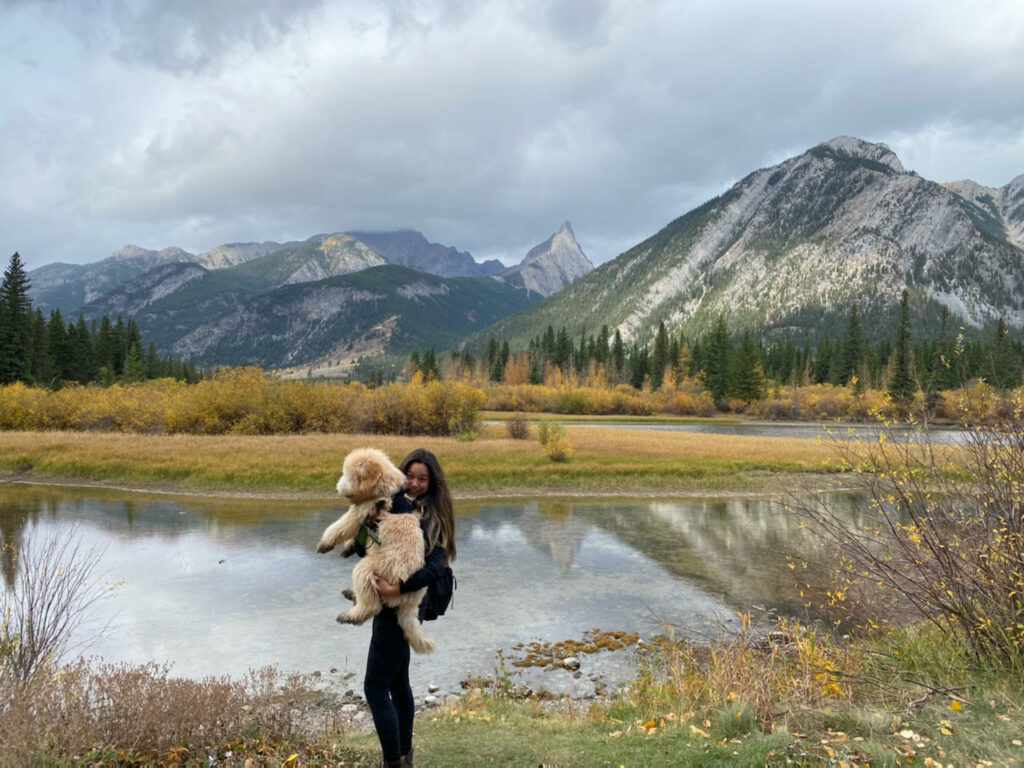 Lauren Shuster, a mother, and her puppy, June, with mountains the background.