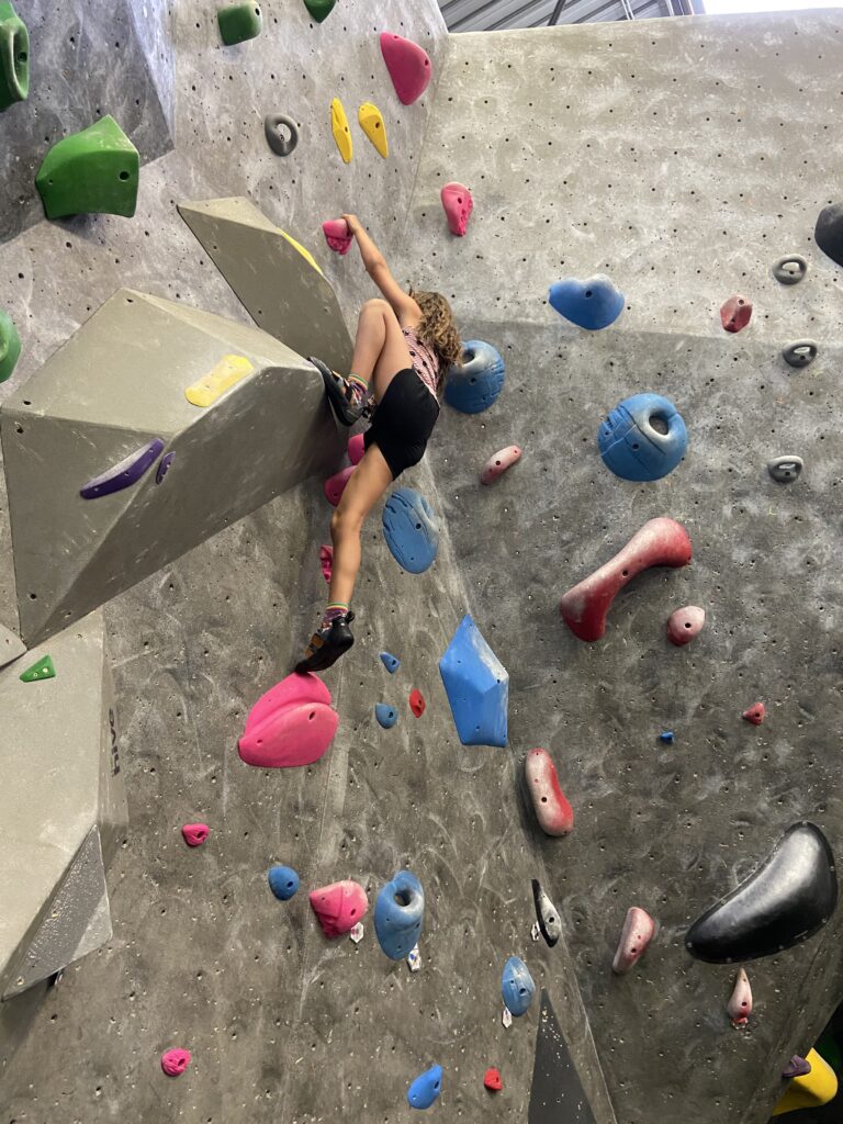 Child rock climbing at Hive Climbing Gym