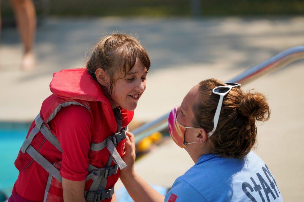 A camper and child at Easter Seals Camp.