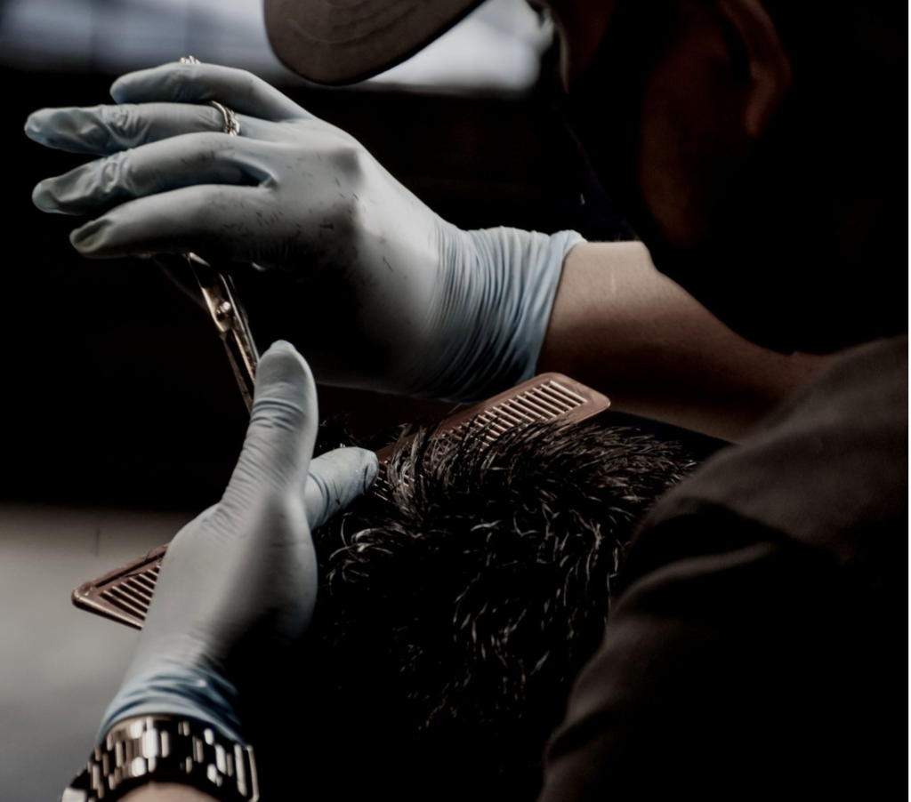 Hands of a guy cutting hair