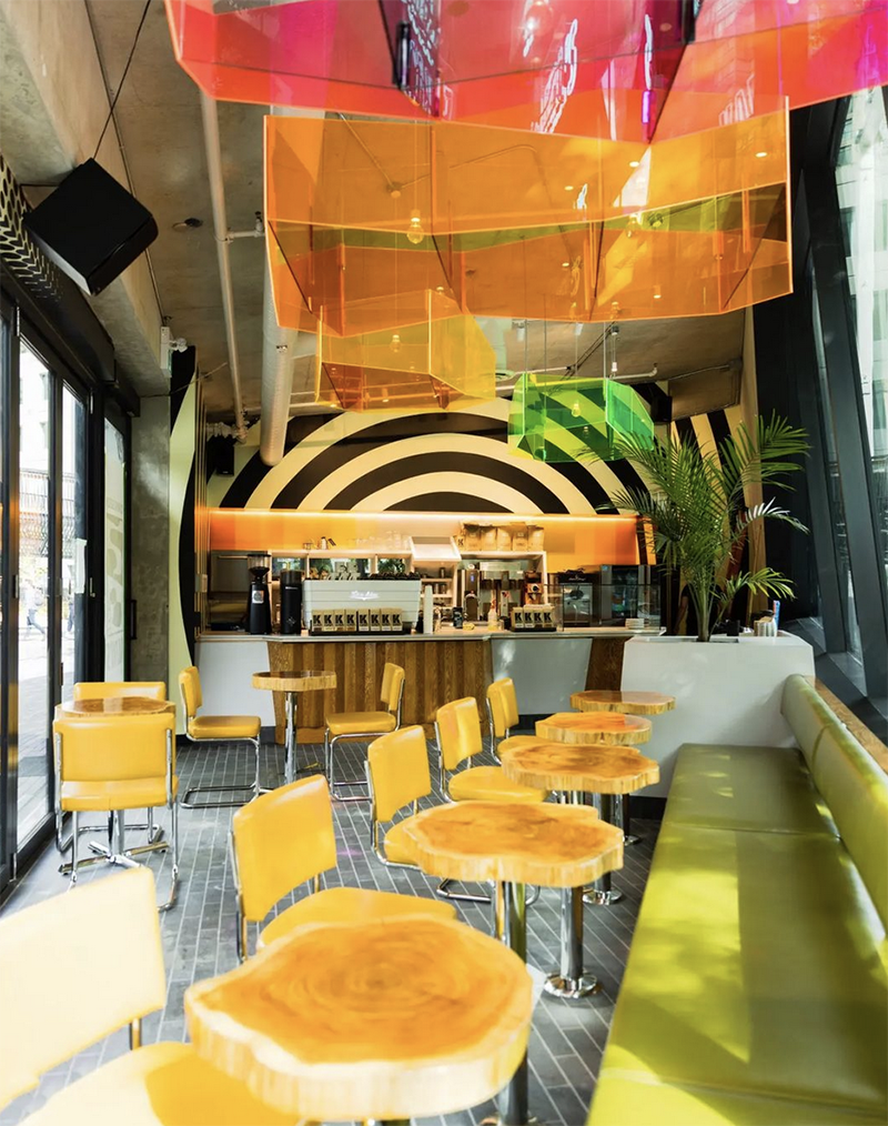 A beautiful sunny photo of the inside of Kafka's Coffee shop in the park in Vancouver.