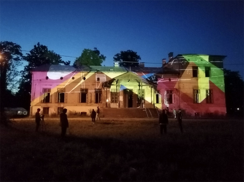 A photo of a building light from the outside by rainbow lights for Vancouver Mom events for kids in November.