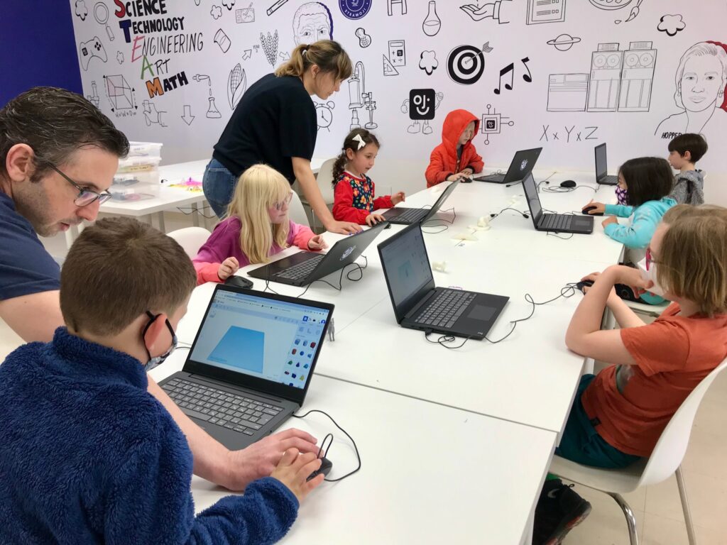 Kids in a classroom learning about STEAM activities