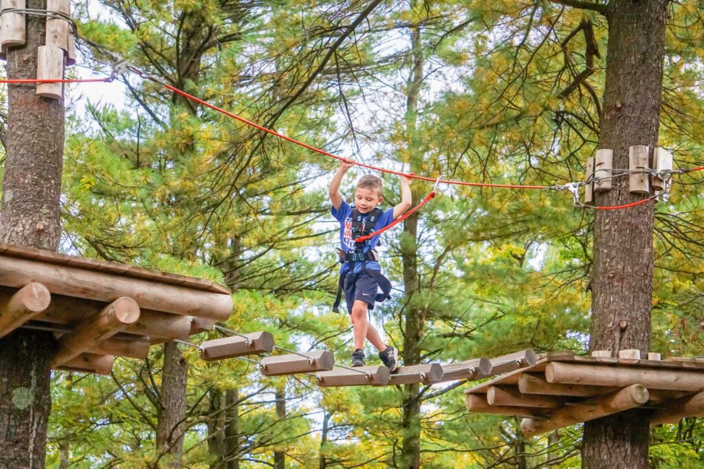 Boy ziplining through the Wildplay parks