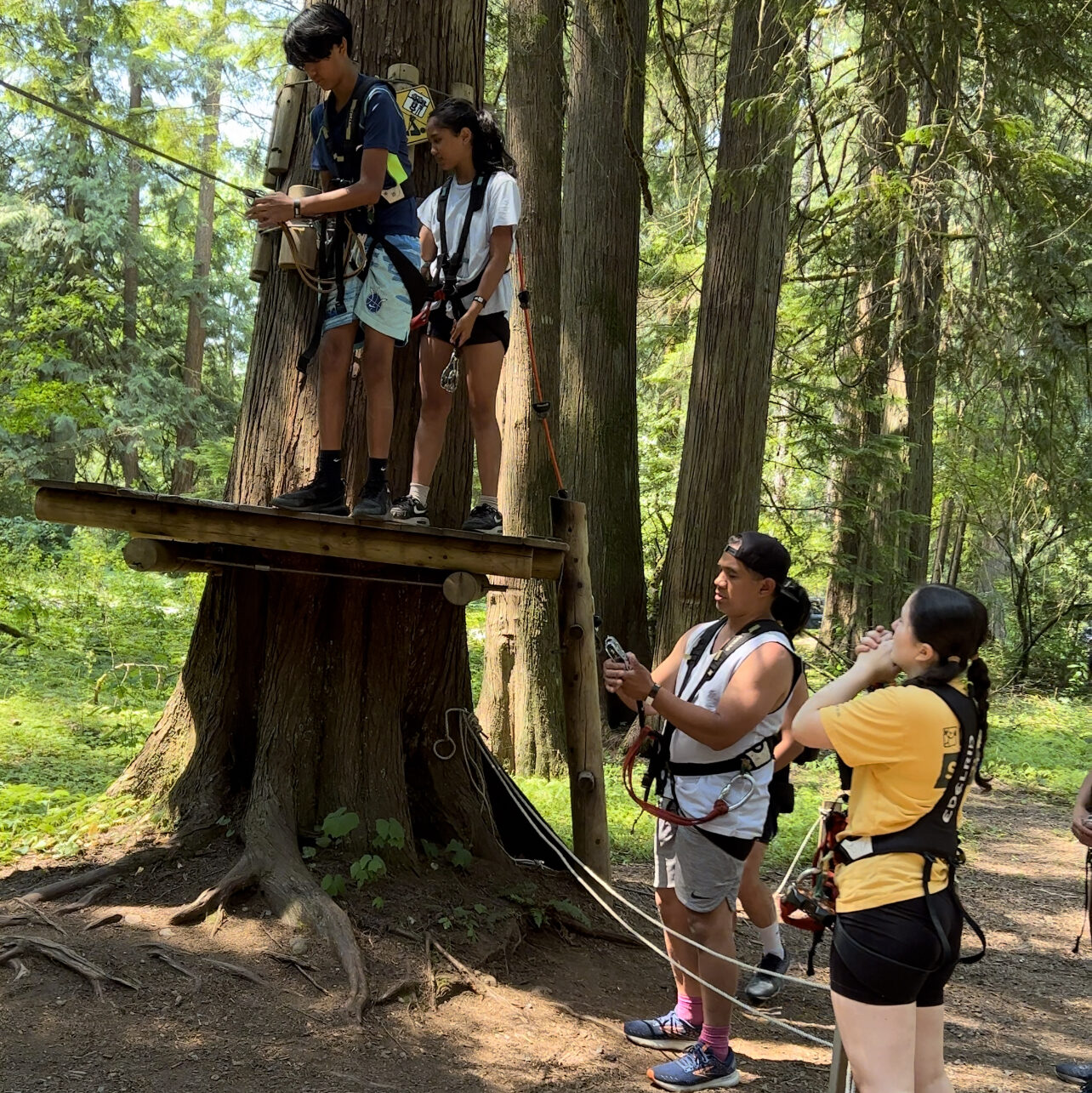 An instructor teaching the group how to go through the obstacles and explaining the safety procedures
