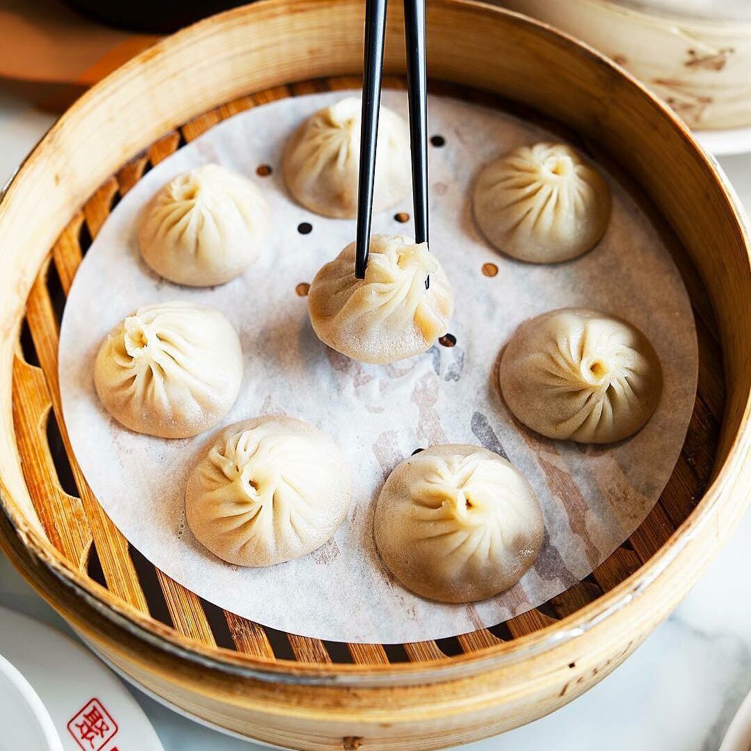 Soup dumplings in a wooden steam basket