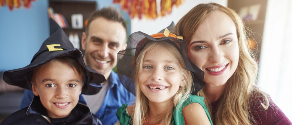 A family picture with 2 kids wearing a witches hat for halloween events in metro vancouver