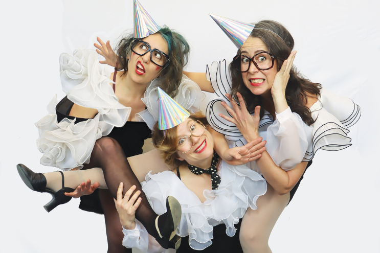 3 ladies dressed up in costumes as performers for the Vancouver International Children's Festival