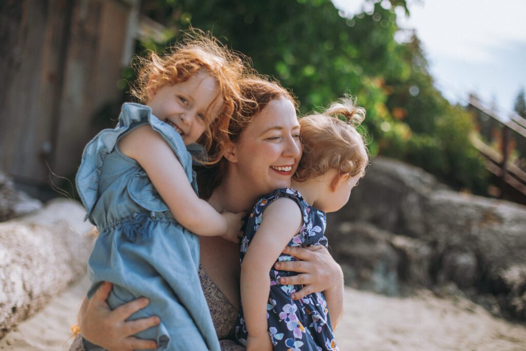 2 little girls with their mom the owner and founder of Little Trees Sleep Consulting
