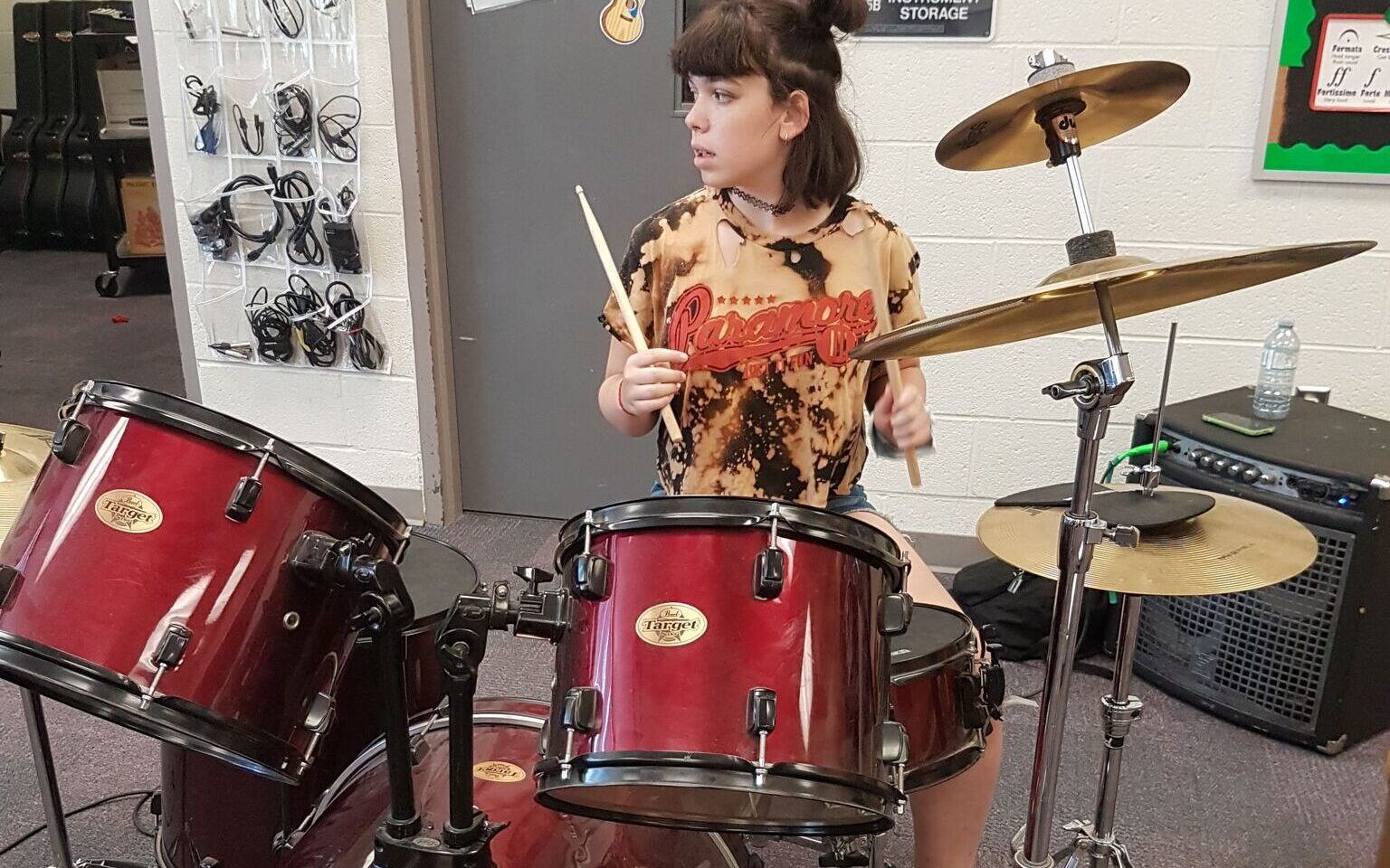 Teenage girl on her drums learning at Rockstar Music Central