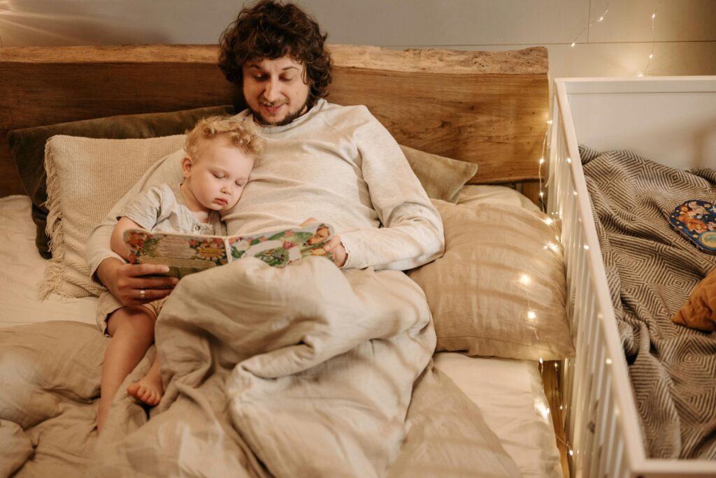 Dad reading a book to his toddler son