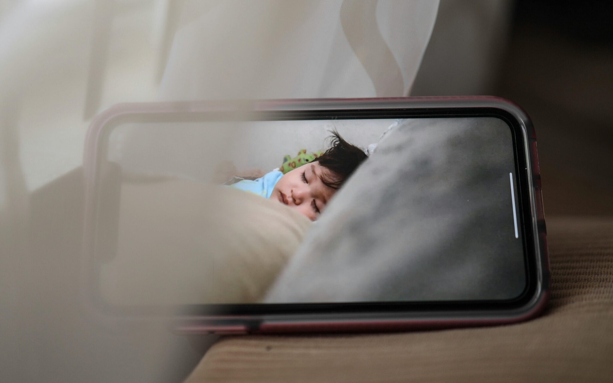 A photo on a cell phone of a baby sleep