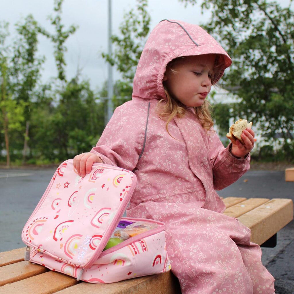 Little girl eaching her lunch showing her Jan & Jul lunchbag in pink for back to school must haves