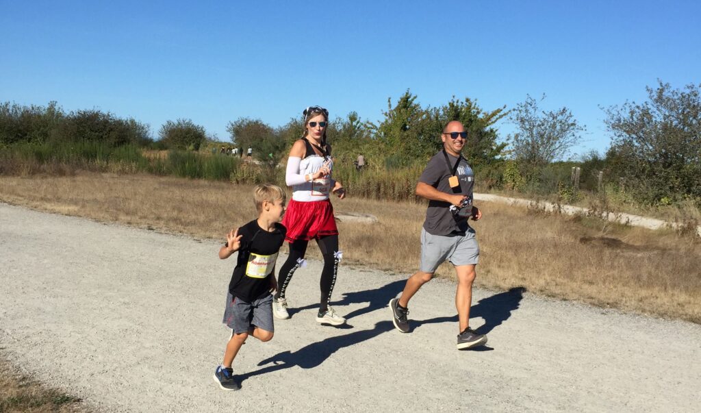 A family of 3 running for the Big Fun Run series of the Pirate Run
